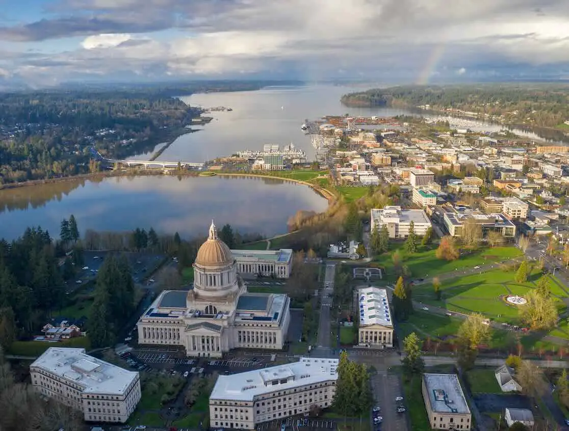 Aerial view of the Washington State Capitol dome, Capitol Lake and downtown Olympia on Budd Inlet, with a rainbow.